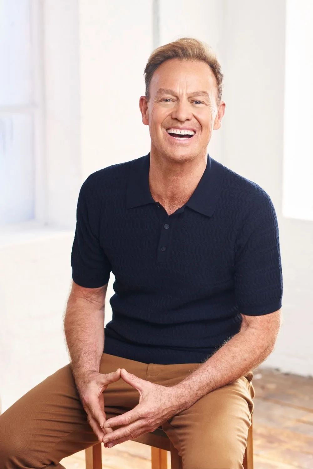 Jason Donovan posing on a chair