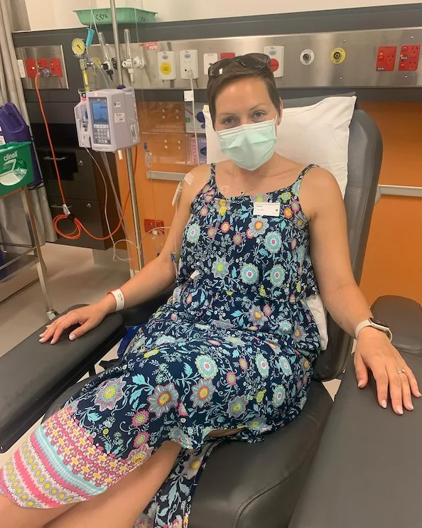 Hilland with a mask on in hospital