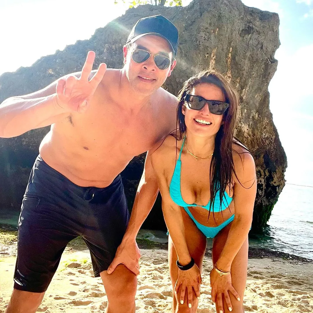 James Stewart and Ada Nicodemou posing on a beach