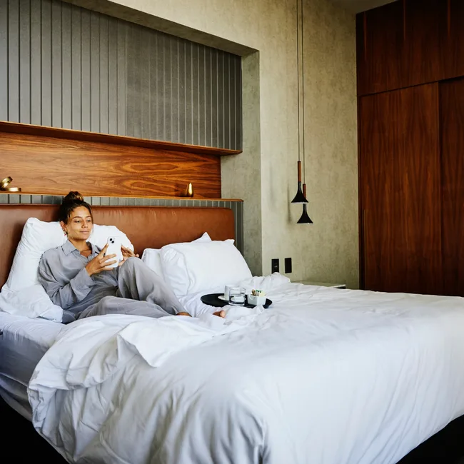 Woman enjoying her hotel stay, thanks to a Black Friday booking deal.