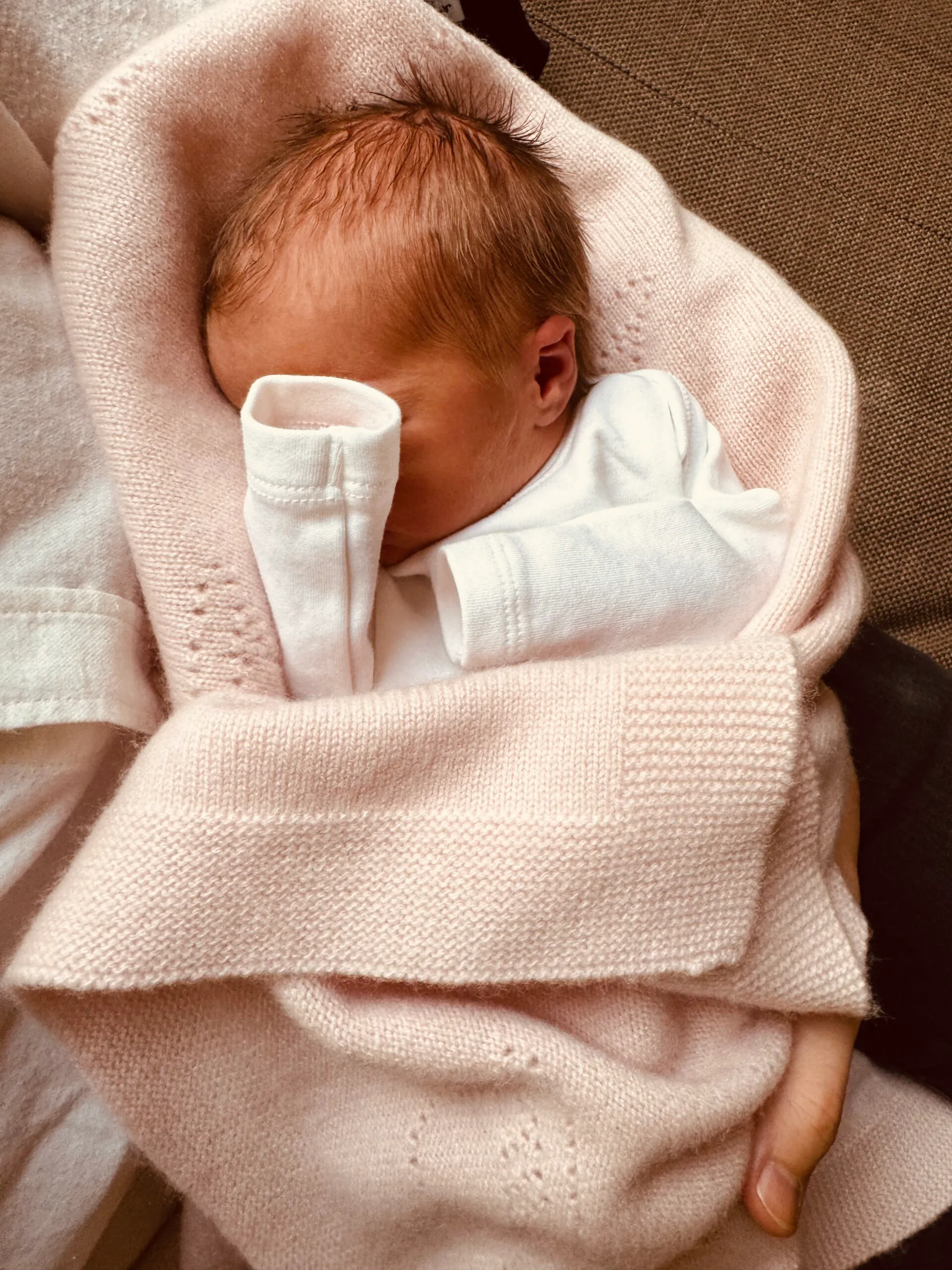 Princess Beatrice's second daughter Athena lays in a pink baby blanket