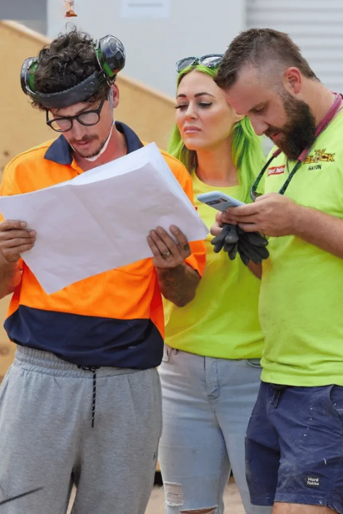 The Block's Kylie and Brad looking at blueprints.