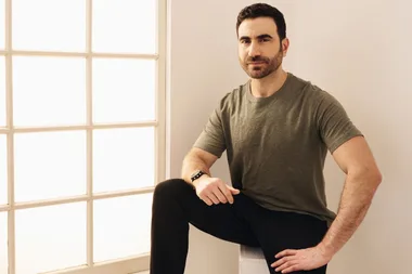 Brett Goldstein wears a green t-shirt and black pants