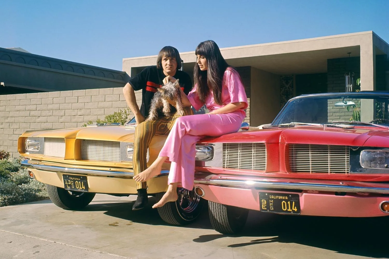 Sonny and Cher with their gifted Ford Mustang convertibles.