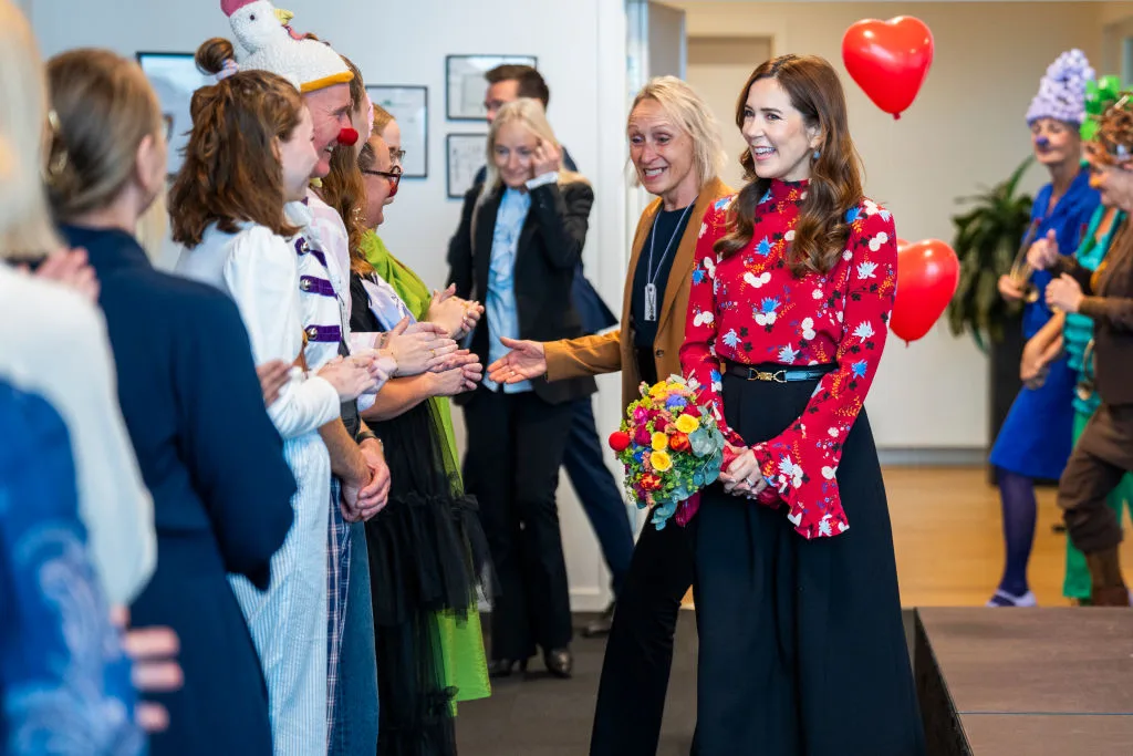 Queen Mary wears a colourful outfit as she visits a hospital