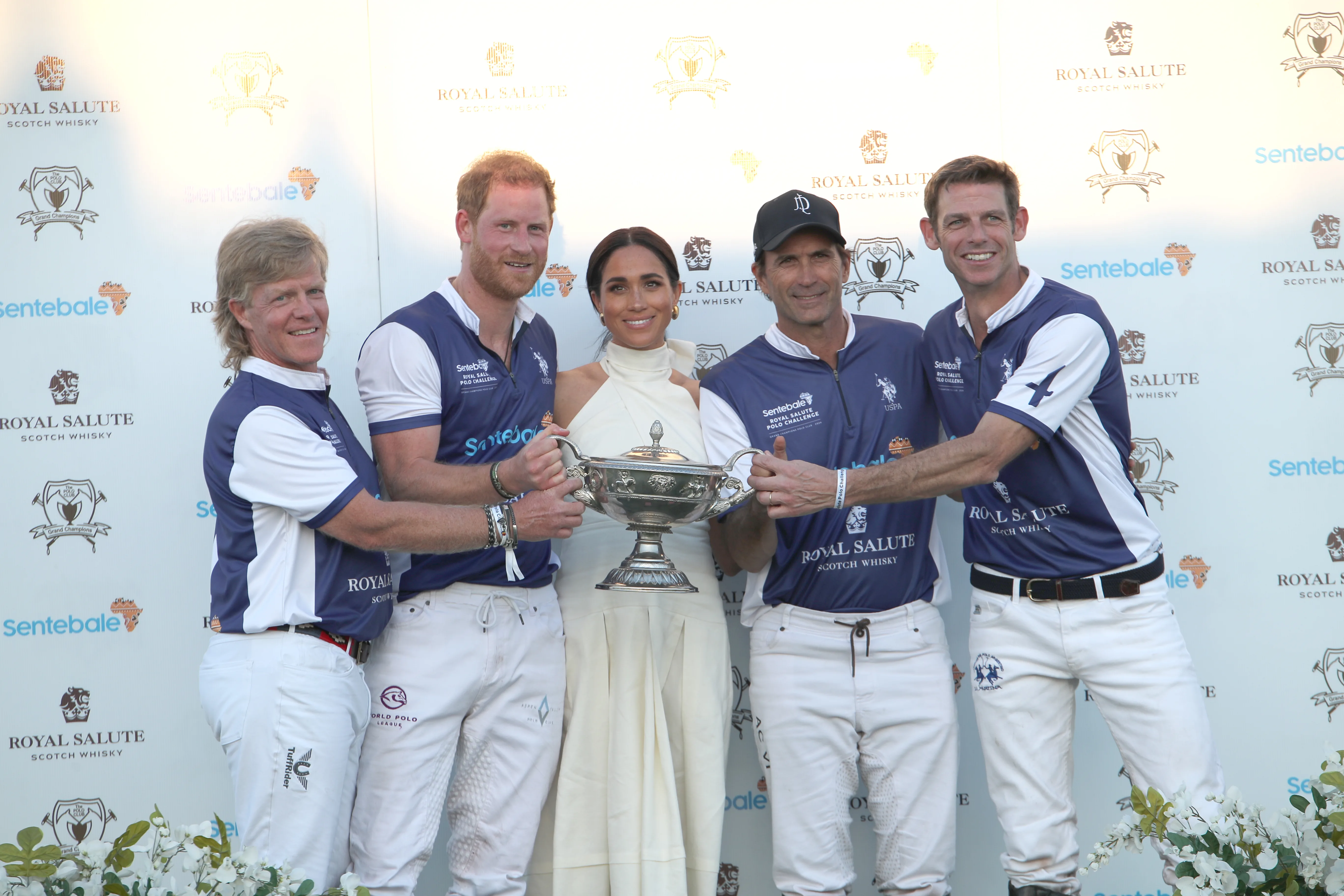 Meghan presents Harry with a polo trophy