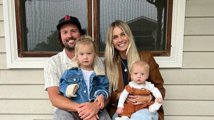 Elyse and Josh alongside two sons.