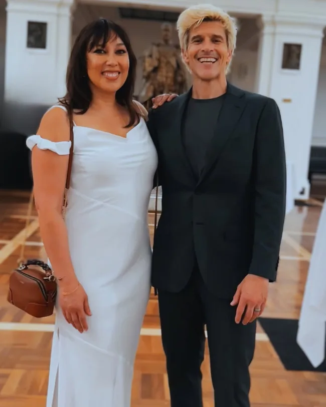 osher gunsberg with blonde hair and wife audrey griffen pose for a photo
