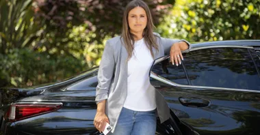 Christie Hayes poses with an Uber as part of a campaign to provide free rides to victims of domestic violence.