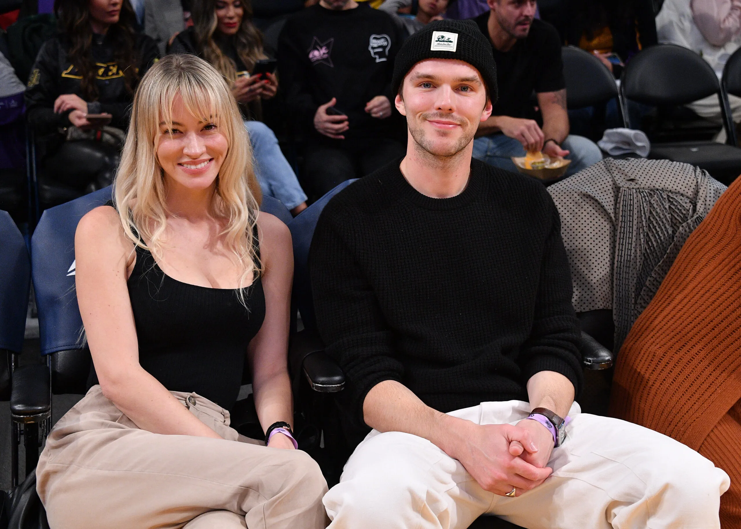 Nicholas Hoult and Bryana Holly attend a basketball game