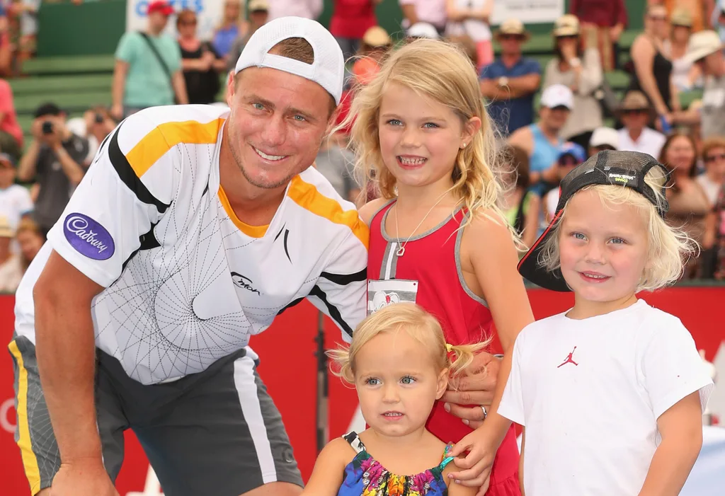 Lleyton Hewitt of Australia poses with the winners trophy and his children Ava Hewitt, Cruz Hewitt and Mia Hewitt after winning his match against Juan Martín del Potro of Argentina during day four of the AAMI Classic at Kooyong on January 12, 2013 in Melbourne, Australia.