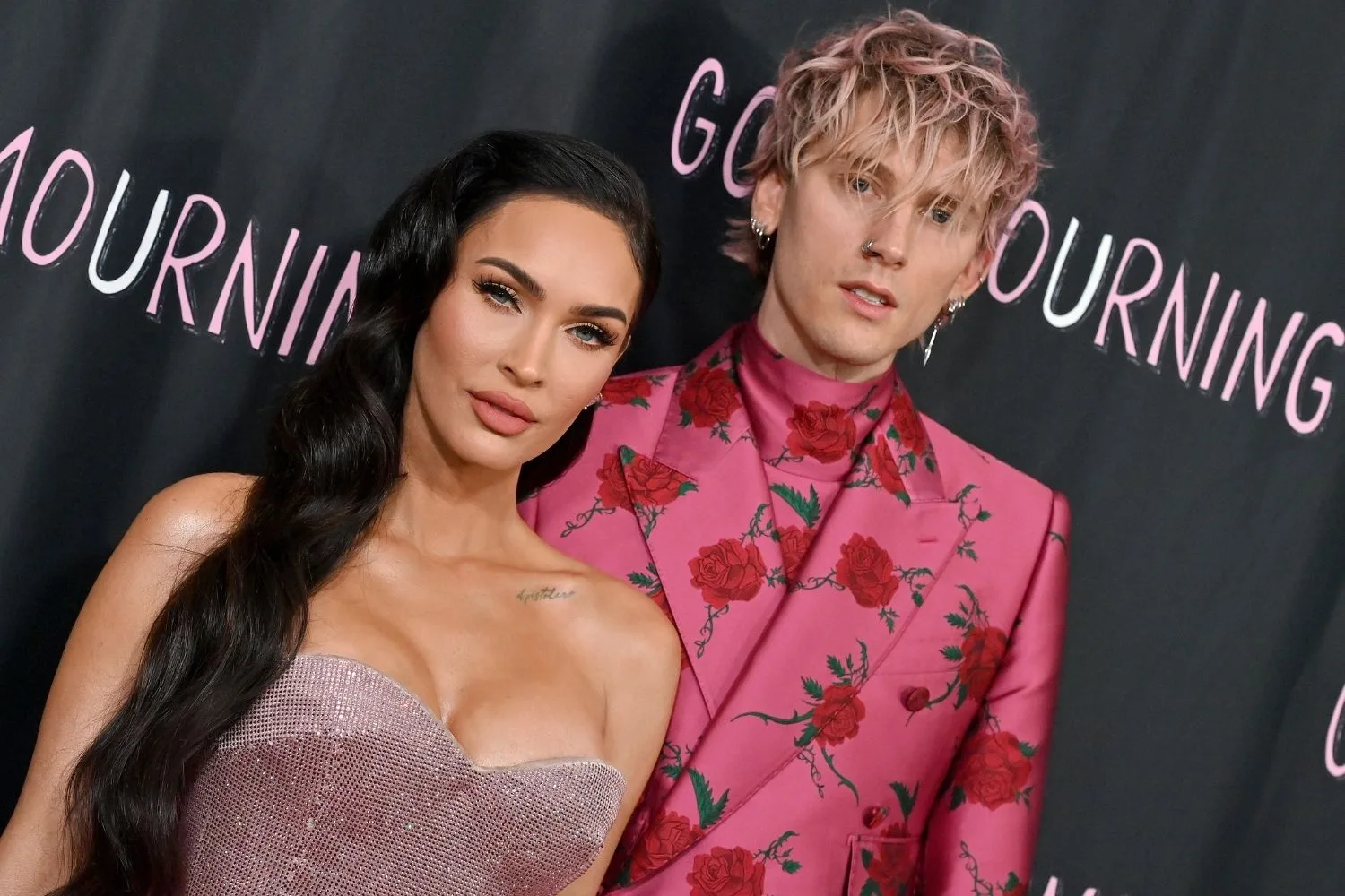 Machine Gun Kelly in a pink suit and Megan Fox in a strapless dress