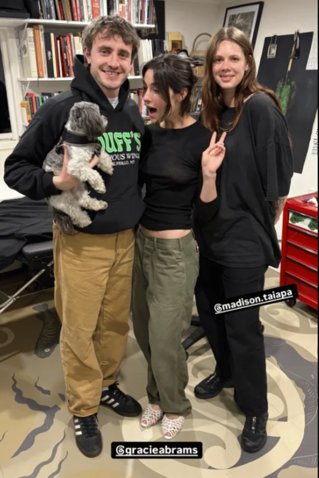 Paul Mescal Gracie Abrams take a photo with a dog