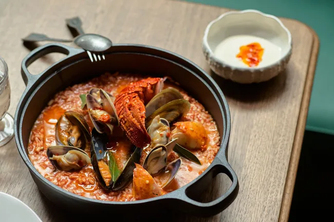 A pot of seafood with a red sauce