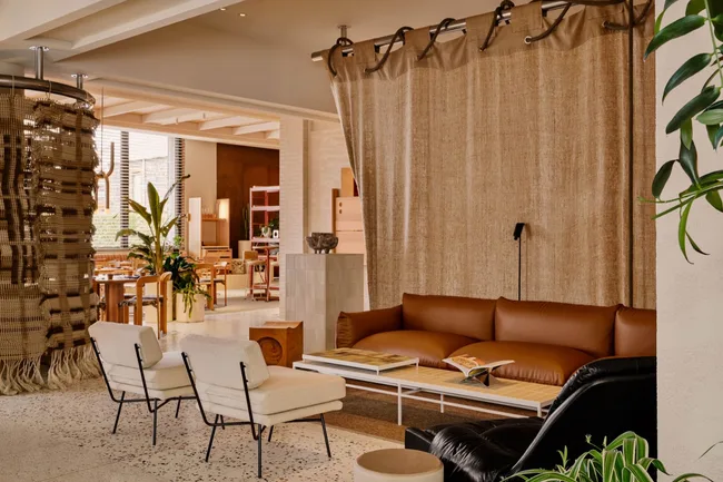 Hotel lobby with tan couch and neutral chairs