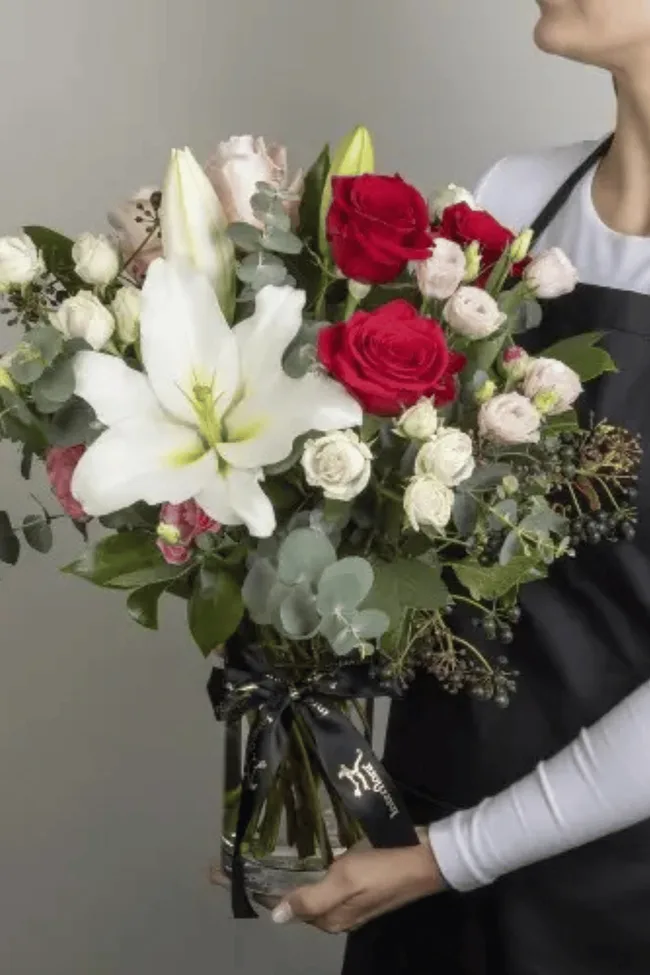 A woman holding a bouquet of flowers.