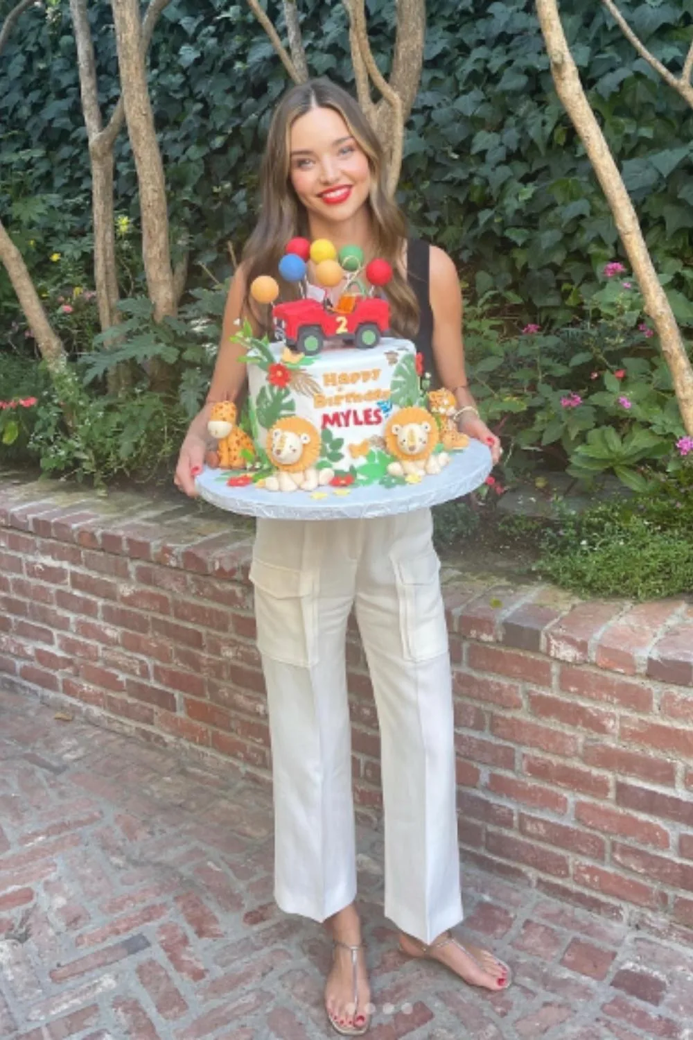 Miranda Kerr holds an elaborate birthday cake for her son Miles 2nd birthday