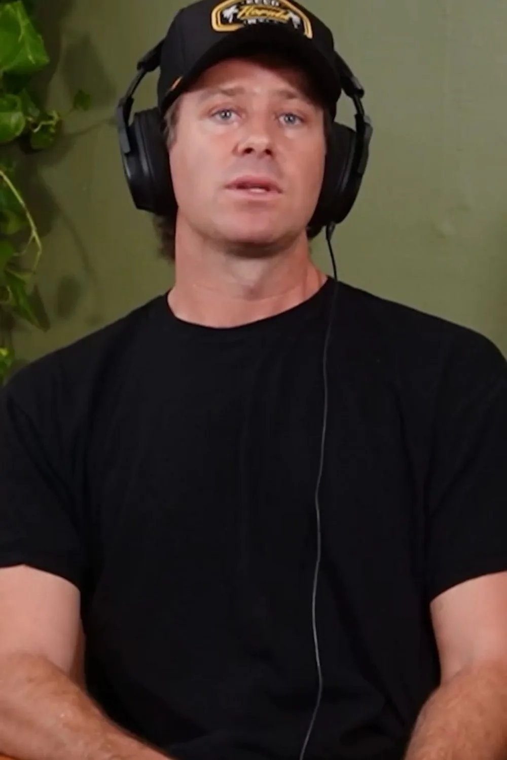 Armie Hammer wears a hat and headphones