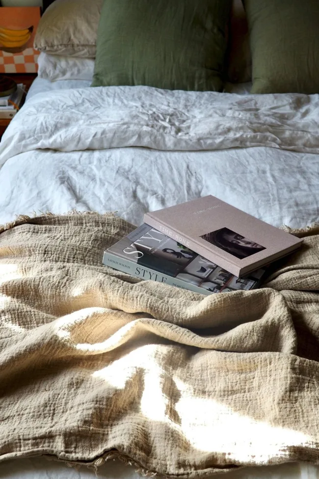 TSL Co Linen throw on a bed with two books