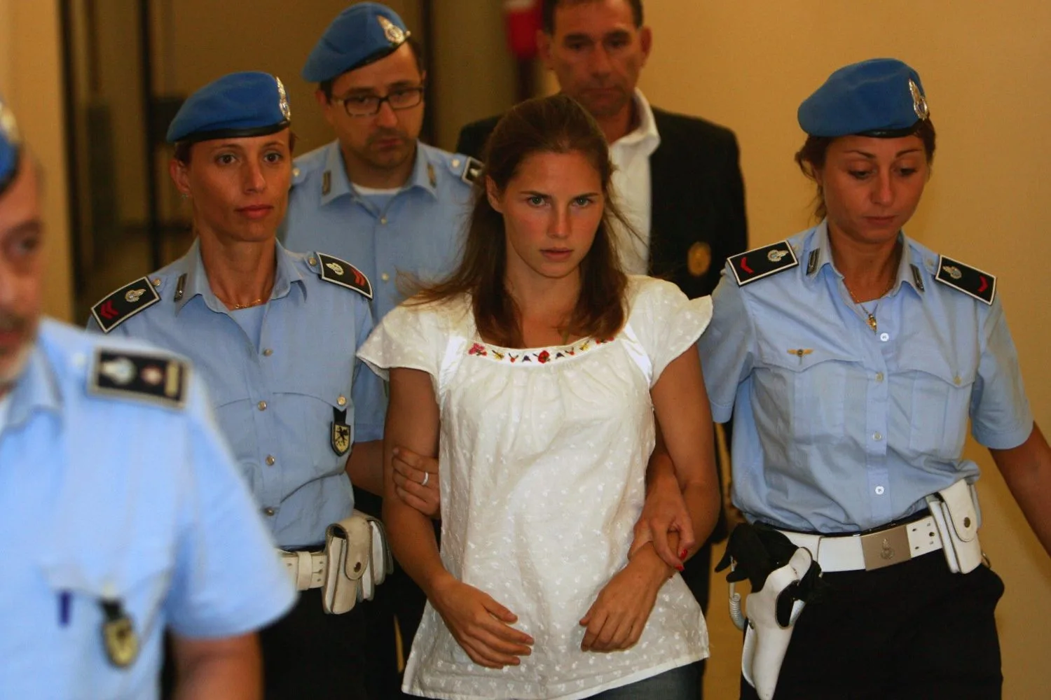 Amanda Knox with police after being arrested 