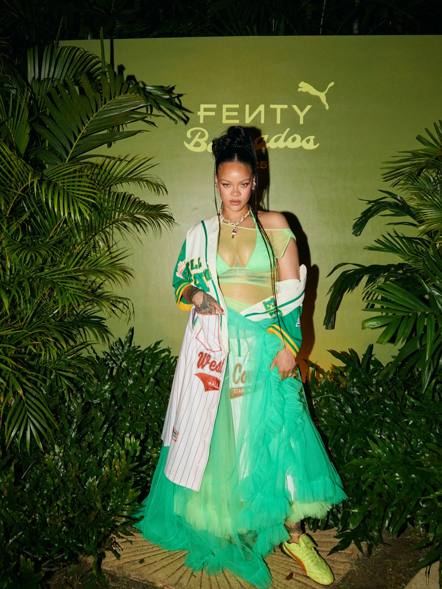 Fashion icon Rihanna wears a neon tutu dress with a bikini top and her latest Puma Avanti LS sneakers at a Fenty x Puma party in her home country of Barbados on March 11., Rihanna completed her eye-catching look with a baseball jersey as she partied with guests including Puma athletes Skylar Diggins-Smith, Charokee Young, and Shericka Jackson, along with Serena Page, Kordell Beckham, Achieng Agutu, Isan Elba, Avani, Rickey Thompson, Jaida Buni, Nate White., The new Fenty x Puma collection is now available worldwide at PUMA.com, Puma flagship stores and select global retailers., *MANDATORY BYLINE - MUST CREDIT: Dennis Leupold/PUMA/Mega. 11 Mar 2025 Pictured: Rihanna celebrates the new Fenty x Puma collection with a release party in Barbados. *MANDATORY BYLINE - MUST CREDIT: Dennis Leupold/PUMA/Mega. Photo credit: Dennis Leupold/PUMA/Mega TheMegaAgency.com sales@mega.global (Mega Agency TagID: MEGA1282827_006.jpg) [Photo via Mega Agency]