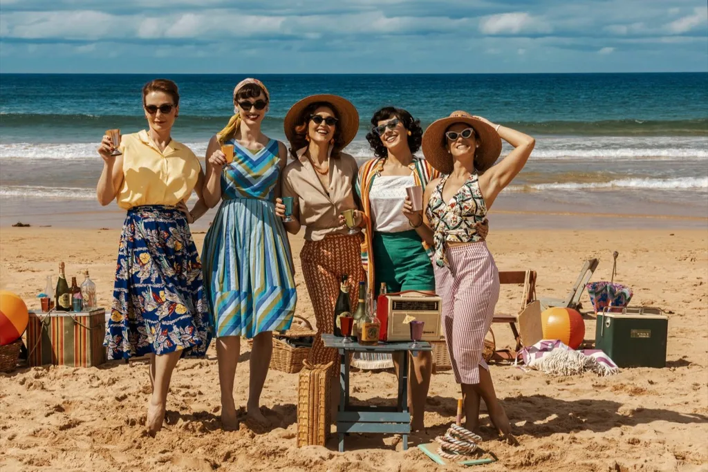 Stars of Ten Pound Poms pose on the beach