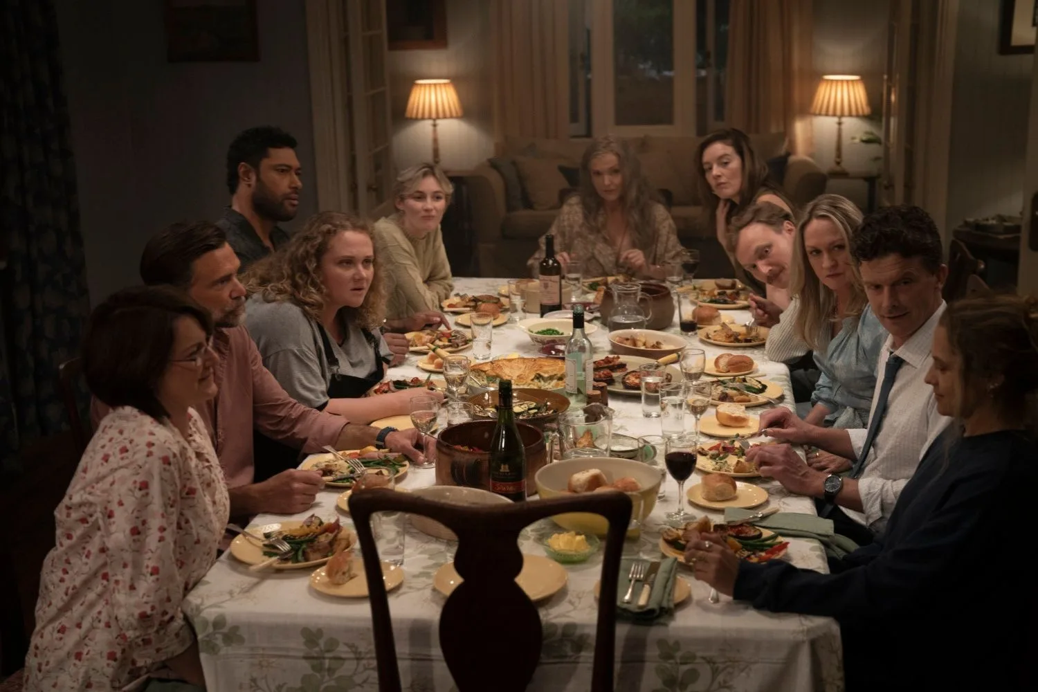 A group of people sit around a dinner table in a scene from The Last Anniversary