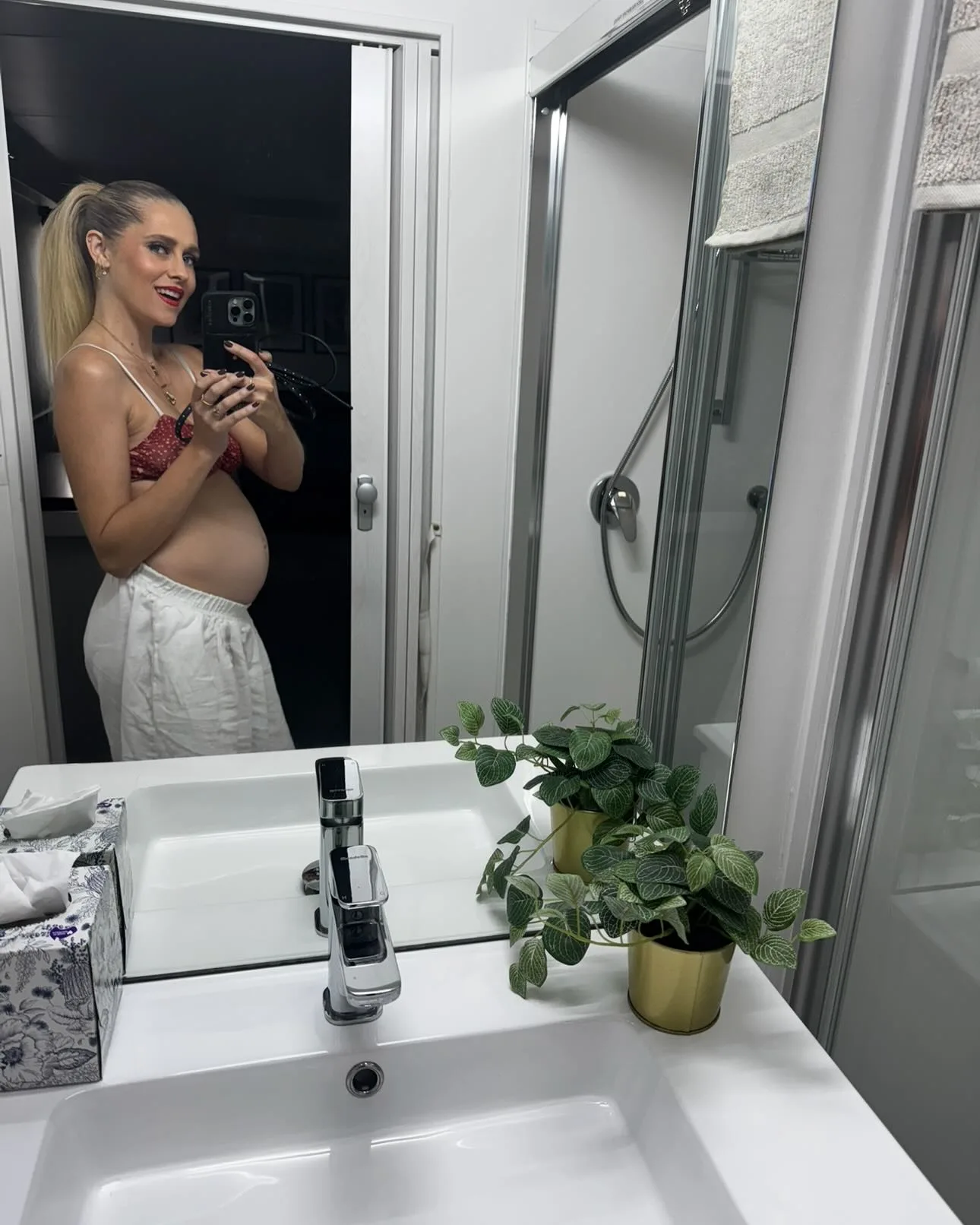 Pregnant Teresa Palmer takes a photo of herself in front of a mirror