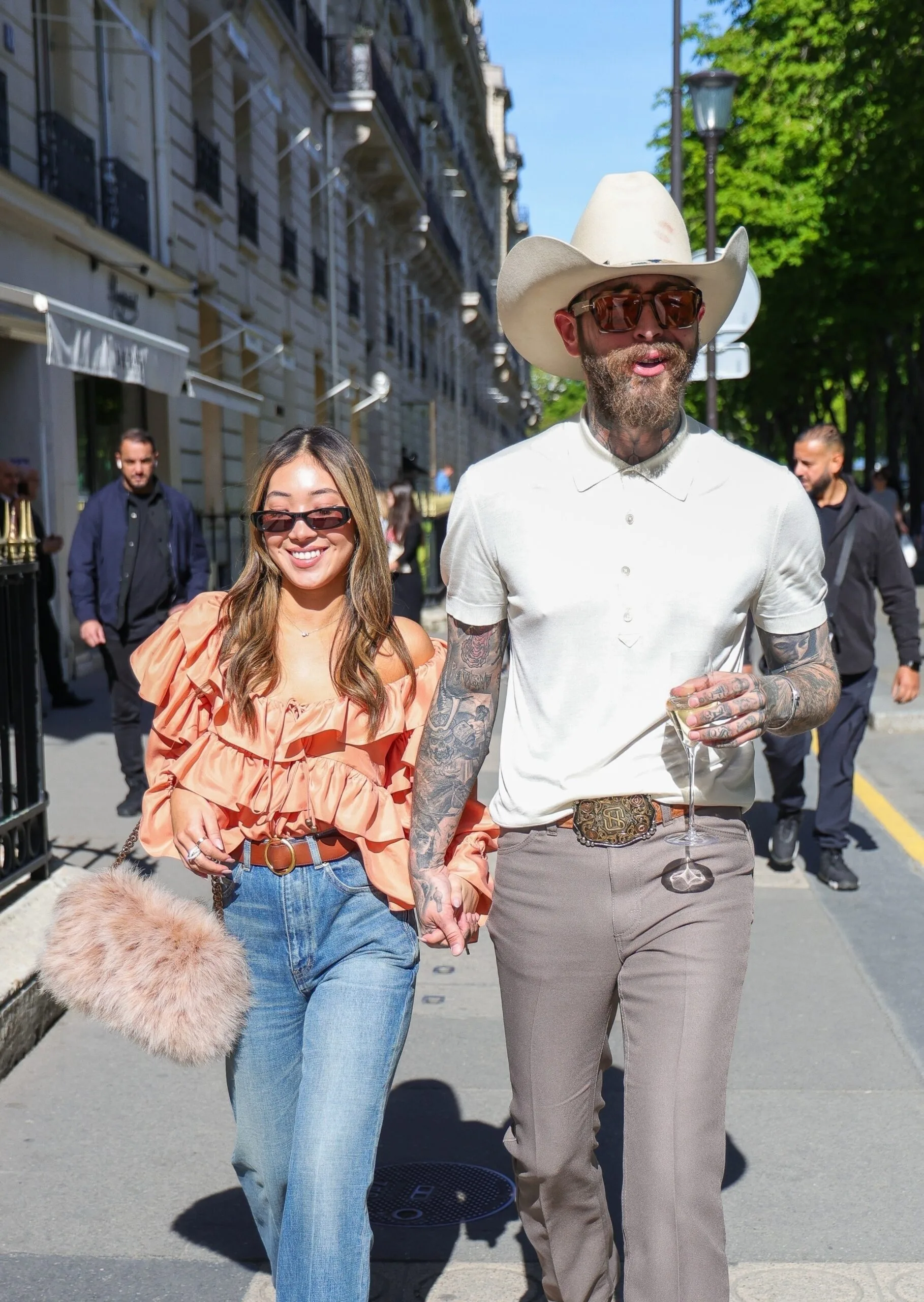 AU_3202230 - Paris, FRANCE  -  Stylish couple Post Malone and Christy Lee take a stroll down Avenue Montaigne during a romantic weekend in Paris, France.