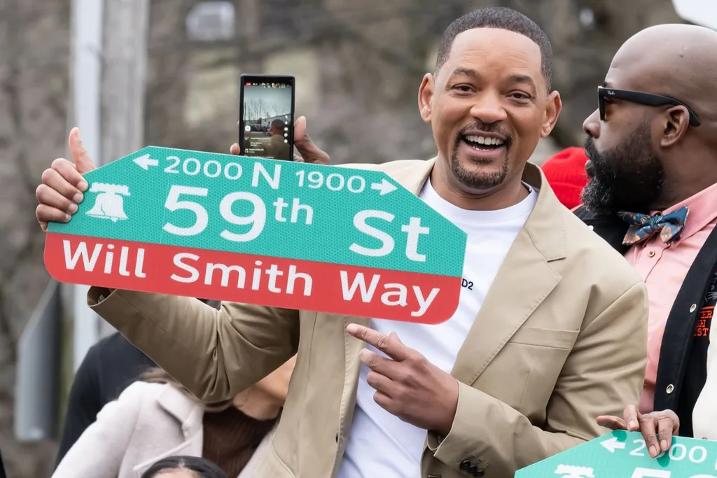 Will Smith with a street sign