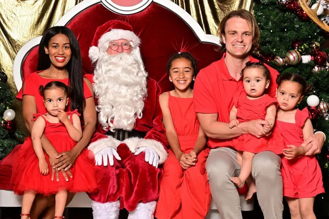 Australian reality tv couple mary and conor from bachelor in paradise pose with a mall santa with their four kids