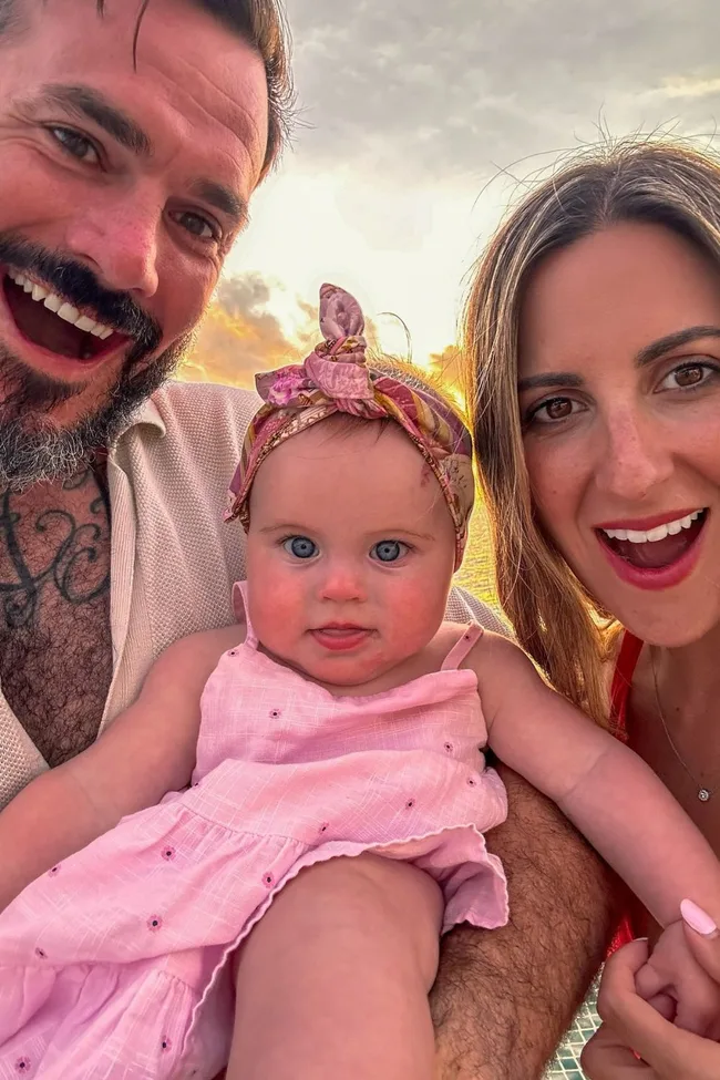 Australian reality tv couple irena and locky from the bachelor with their baby girl