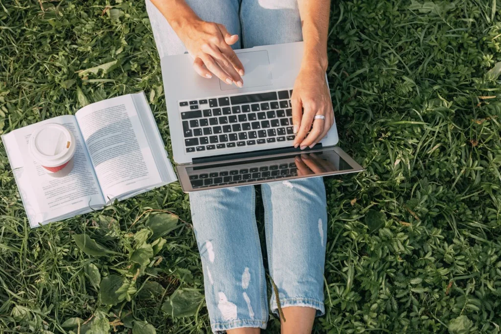 a woman works on a laptop