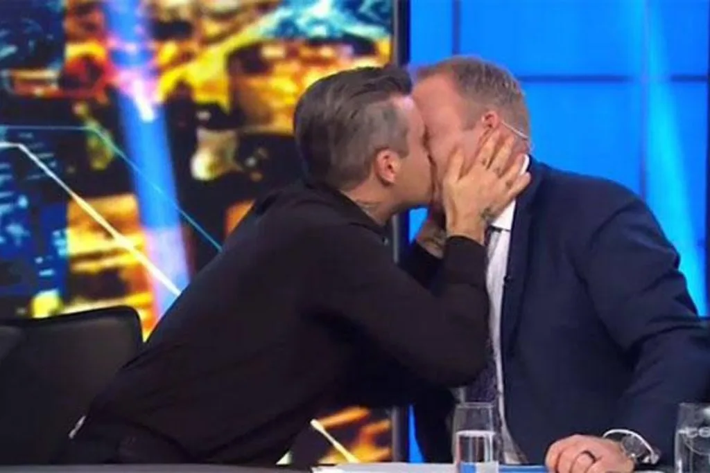 Robbie Williams kissing Peter Helliar