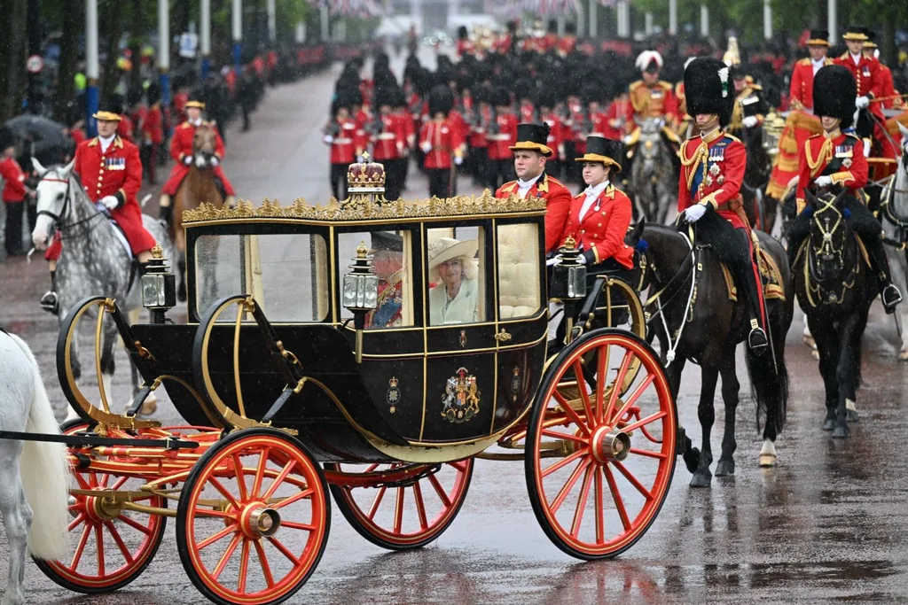 the king rides in a carriage at Trooping