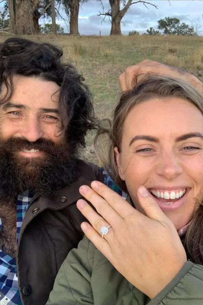 Farmer Wants A Wife Benjamin Jackson and Hannah Gracey smiling while Hannah holds up her engagement ring.