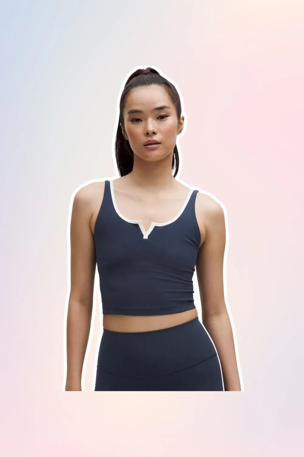 Navy Pilates activewear cropped tank top with white ribbing. 