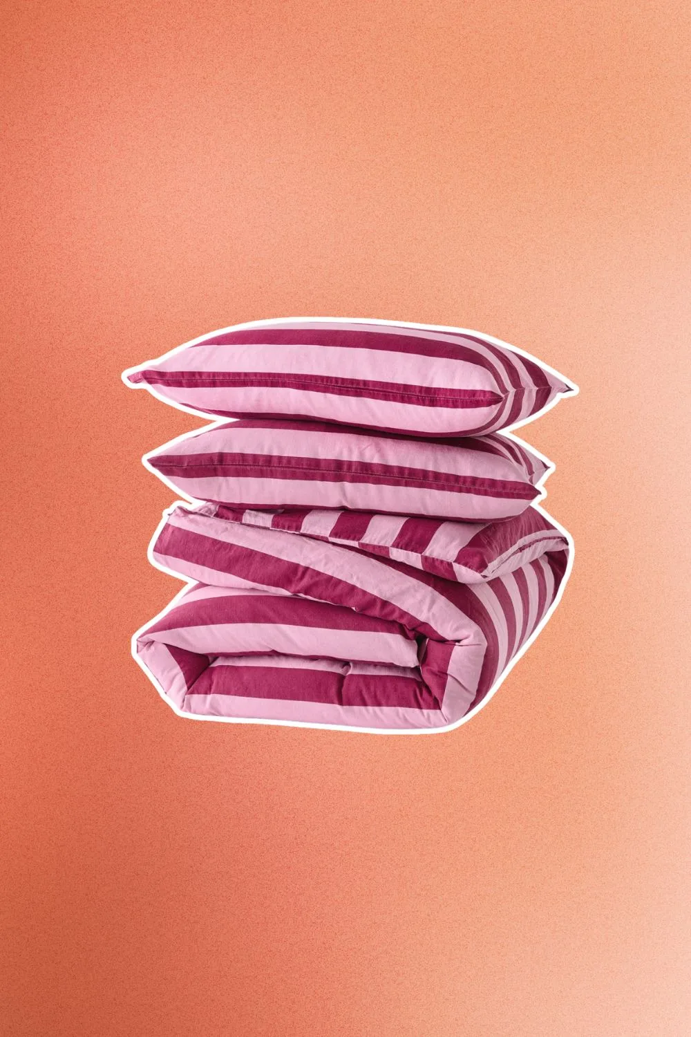 stack of red and pink striped kmart quilts and pillows.