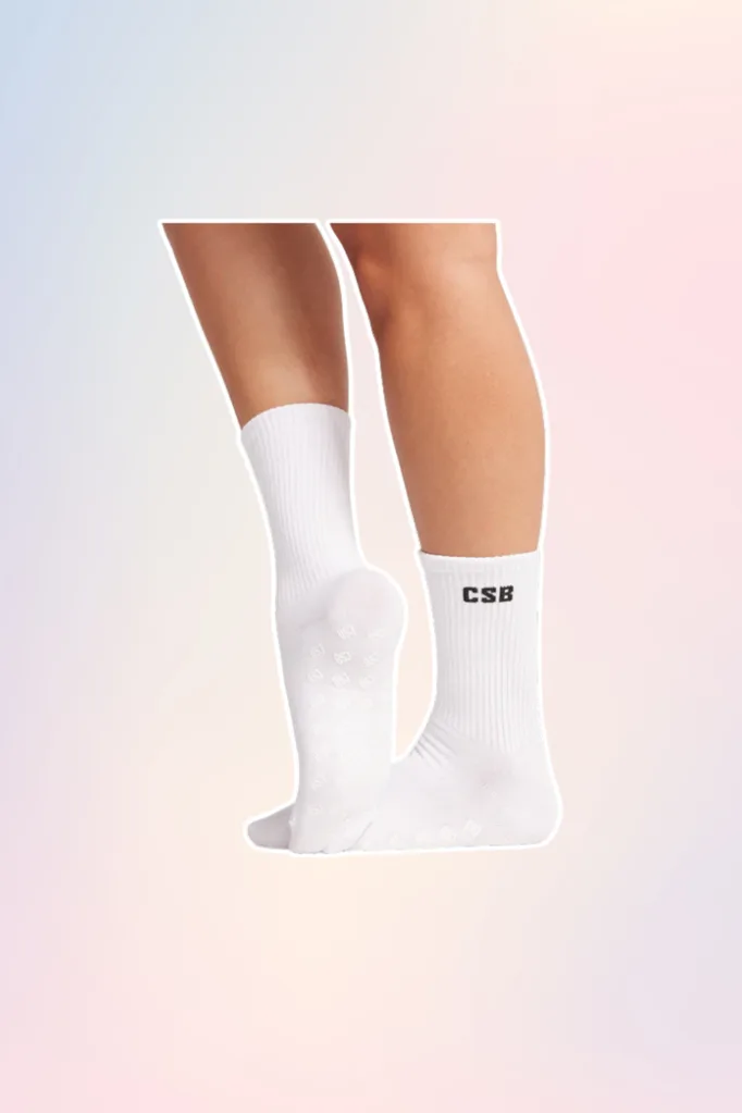 White Pilates grip socks with CSB in black print.