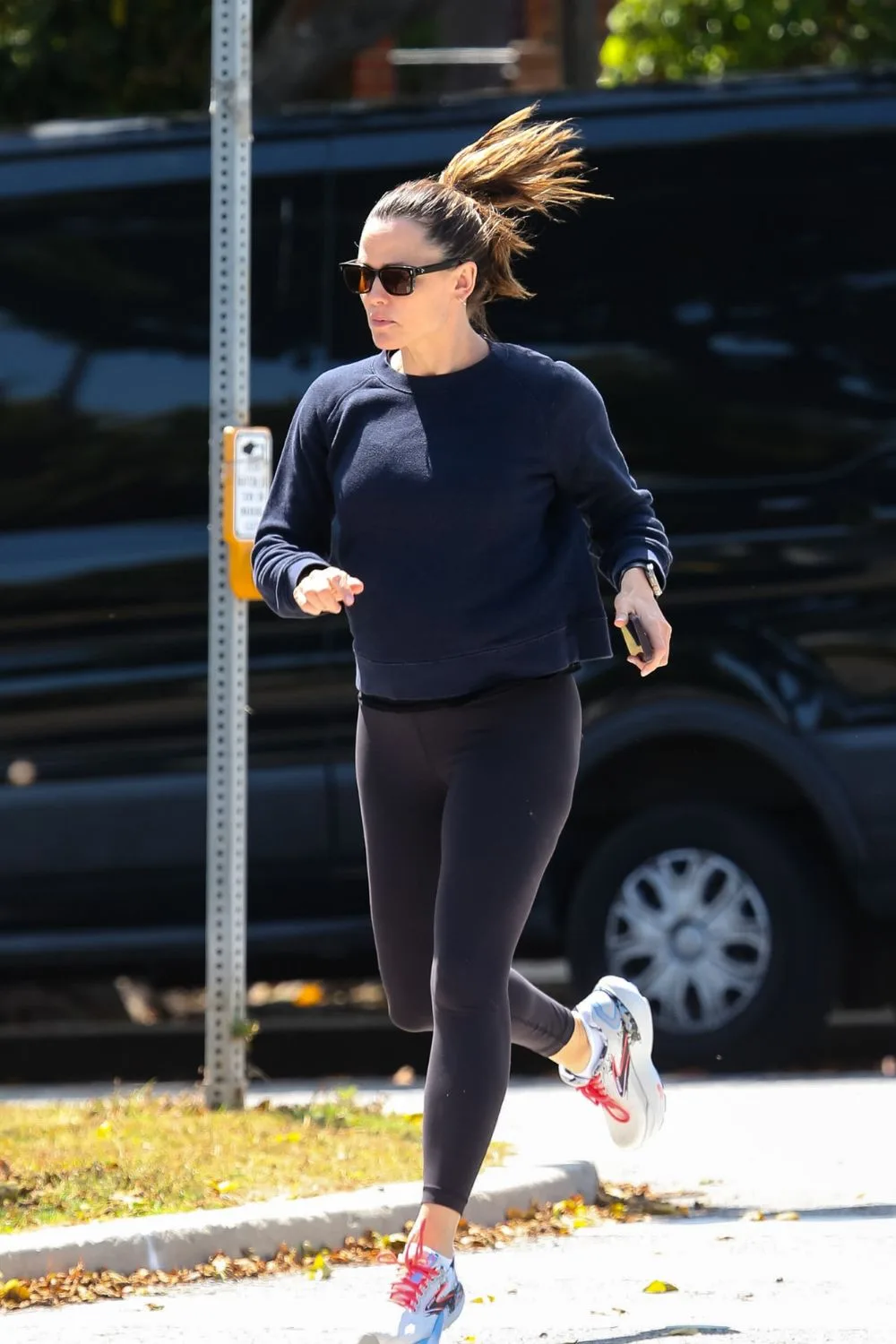 Woman running in all black