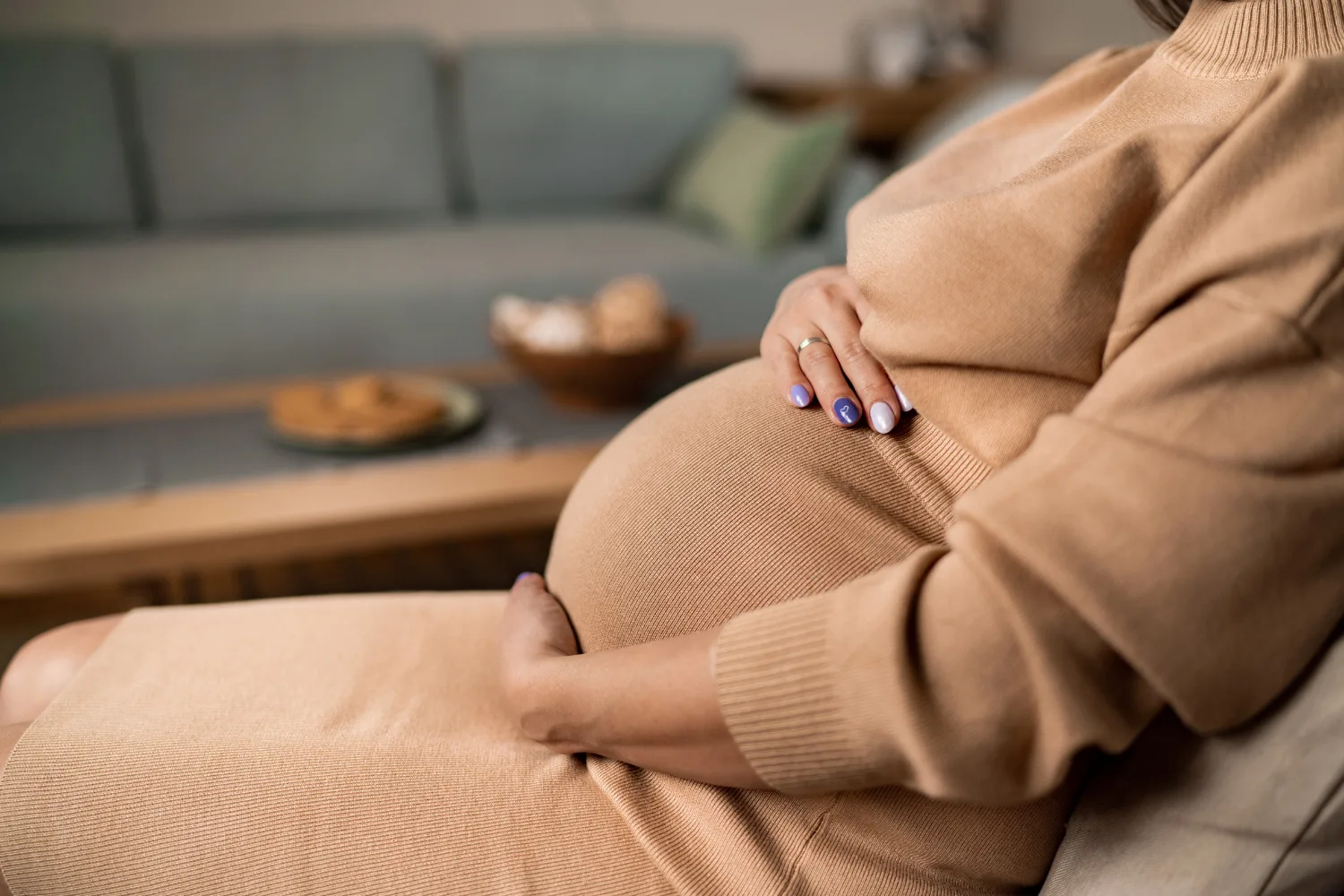 freezing eggs - a pregnant woman cradling her bump