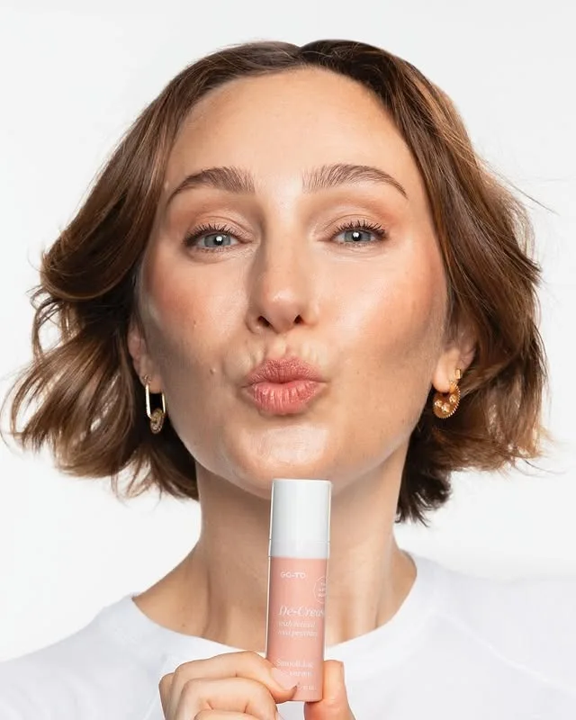 Zoe Foster Blake posing in a kiss face with one of her skincare products