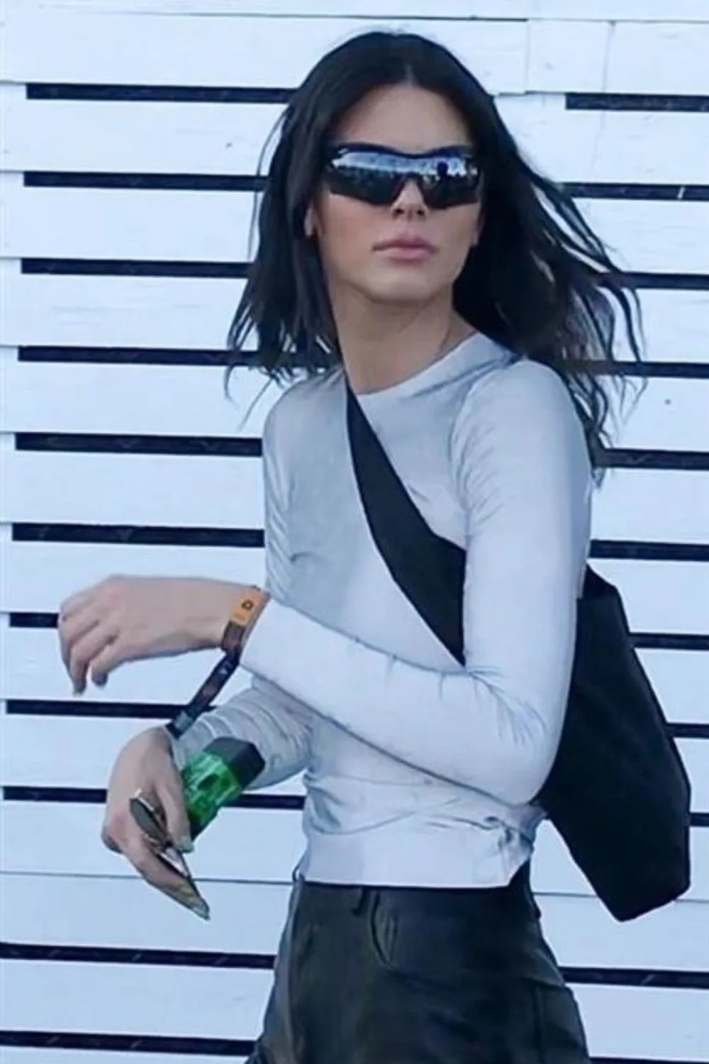 kendall jenner holding a camera with sunglasses on 