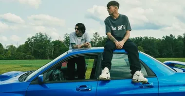 zayn malik louis tomlinson on top of a car