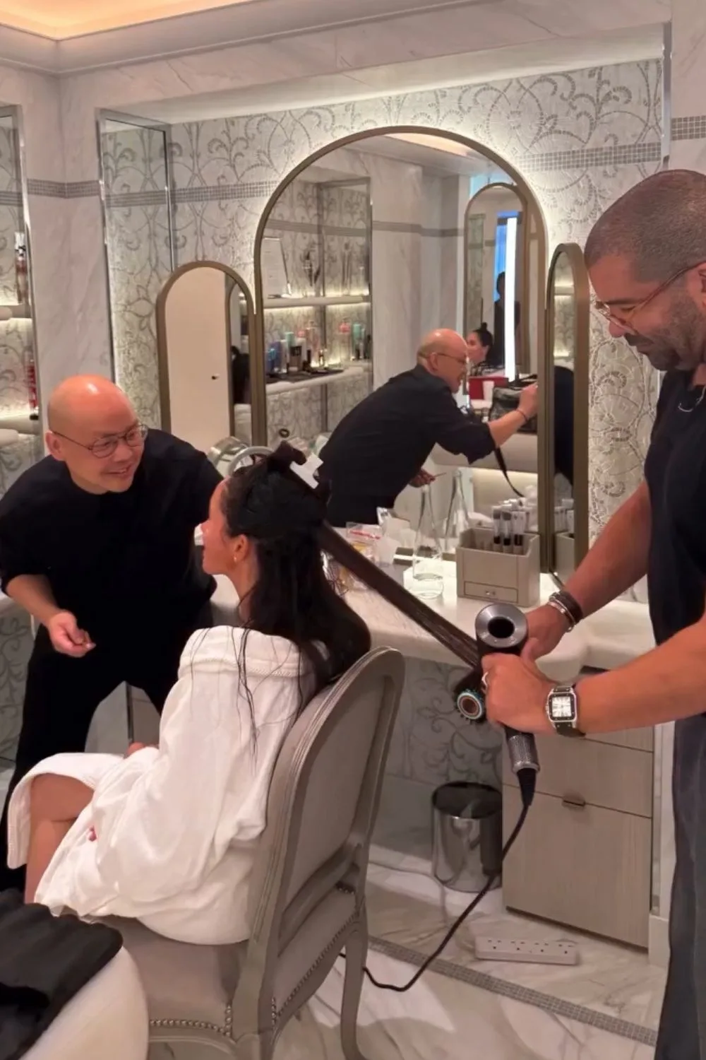 Meghan getting her makeup done at Paris Fashion Week 