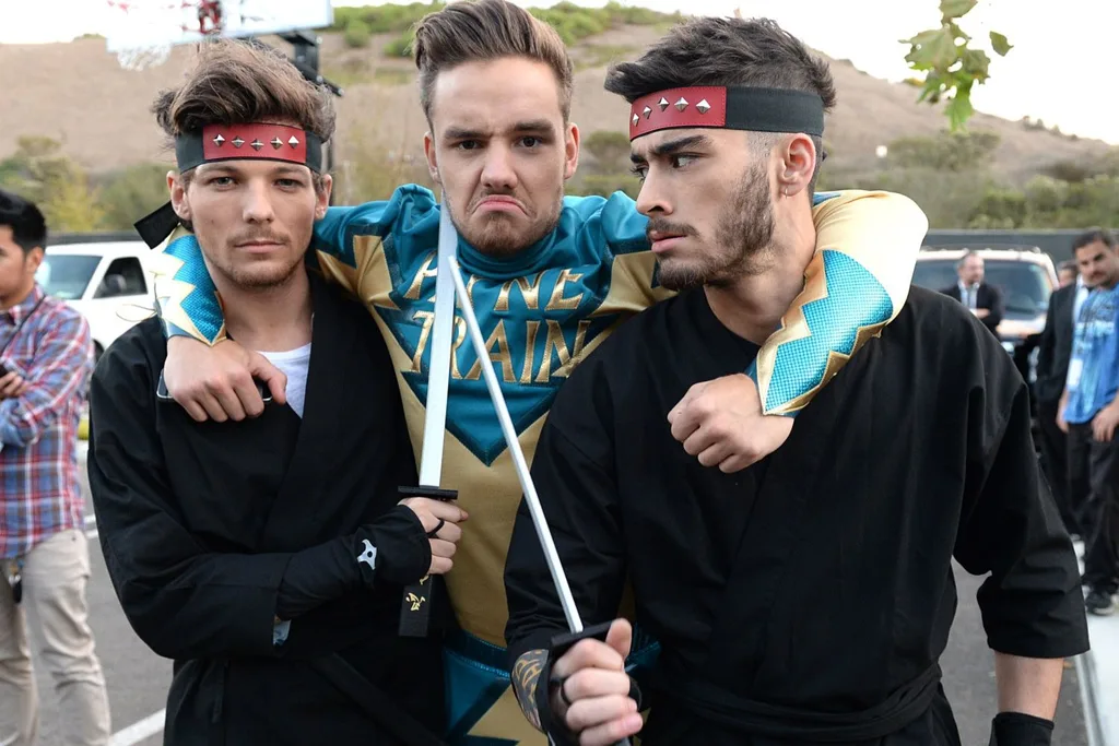 zayn malik, louis tomlinson and liam payne dressed up for a fight skit with their arms around each other