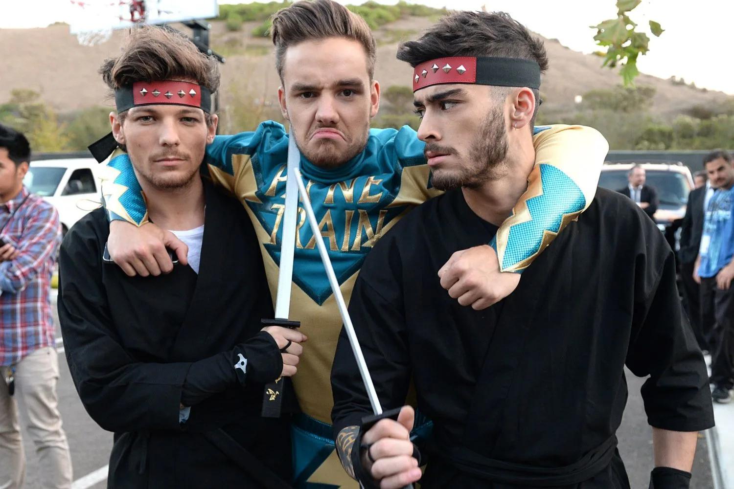 zayn malik, louis tomlinson and liam payne dressed up for a fight skit with their arms around each other