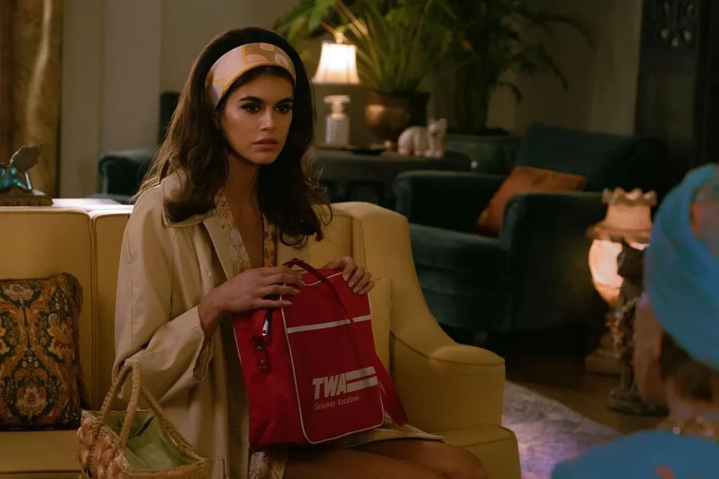 Kaia Gerber in Palm Royale dressed in 60s style clothing.