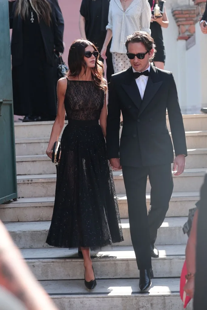 kaia gerber and lewis pullman walking down stairs dressed all in black