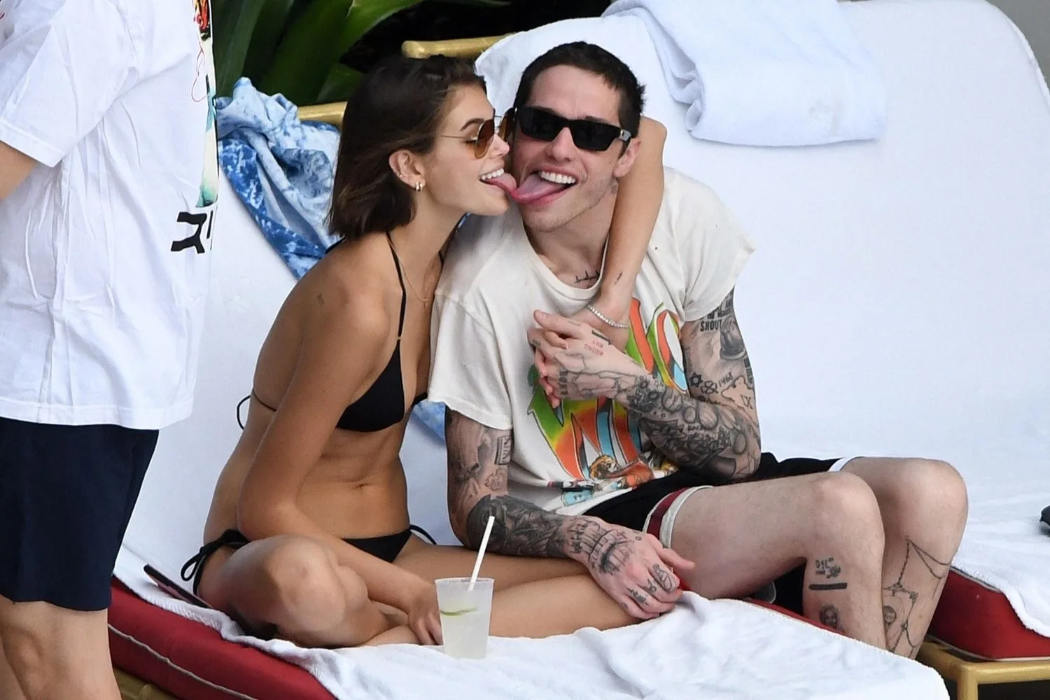 kaia gerber touching tongues with pete davidson on a sun lounger